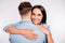 Back side portrait of cheerful lady cuddling her boyfriend wearing denim jeans shirt isolated over white background