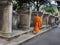Back side of Senior monk walk in ancient temple