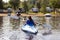 Back side of a woman kayaking on a calm lake