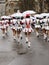 Back side of young majorettes under white umbrella at Carnival p