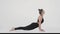 Back strengthening workout. Young active lady wearing black sport suit practicing Downward Dog pose, stretching her body