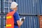 Back of technician who check the quality of cargo containers in shipping area