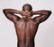 Back to muscle basics. Rearview shot of a muscular african american man holding his hands behind his neck.