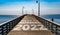 Back to Normal 2022 written on the wooden planks of a pier on the Pacific Coast