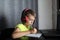 Back to School: Adorable Boy Engaged in Remote Learning with Big Headset