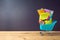 Back to school background with small bag backpack, school supplies and shopping cart on wooden table