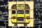 Back to school background with title `Back to school` and `school bus` written on the yellow pieces of paper on the chalkboard