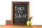 Back to school. Chalk board, books, colored pencils apple