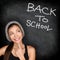 Back to school chalkboard - woman student thinking