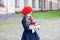 Back to school. Child education and school concept. Little girl in a red beret holds a stack of books with an apple. Ready for sch