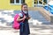 Back to school. Child going school after pandemic over.Portrait of a schoolgirl with a backpack against the background of the