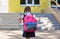 Back to school. Child going school after pandemic over.Portrait of a schoolgirl with a backpack from the back against the