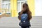 Back to school. Child going school after pandemic over.Portrait of a schoolgirl with a backpack from the back against the