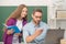 back to school. childhood education. smiling pupil and tutor with laptop. father and teen girl