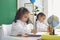 Back to school. Children schoolchildren write while sitting at the table in the classroom.