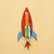 Back to school concept. cardboard rocket cut from paper and painted over wooden yellow background.