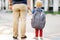 Back to school concept. Little pupil with his father. First day of primary school.