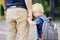 Back to school concept. Little pupil with his father. First day of primary school.