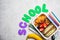 Back to school concept. Lunch box with sandwich, croissants and snacks for school. School background with the inscription, copy