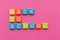 Back to school concept. Phrase `Back to School` from alphabet magnets on pink background