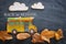 Back to school concept. Top view image of school bus and pencils over autumn dry leaves classroom blackboard background.