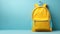 Back to school concept with yellow backpack copy space blue background