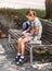 Back to school. Cute little school girl sitting on bench in school yard and eating lunch outdoor. Right school meal for lunch