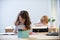 Back to School. Cute pupil writing at desk in classroom at the elementary school. Student girl doing test in primary