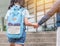 Back to school education concept with girl kid elementary student carrying backpacks holding parent woman or mother`s hand