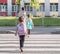 Back to school education concept with girl kids, elementary students, carrying backpacks going to class