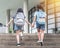 Back to school education concept with girl kids elementary students carrying backpacks going to class