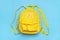 Back to school, education concept. Yellow backpack isolated on blue background. Top view. Copy space Flat lay composition Student