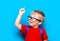 Back to school First grade junior lifestyle. Small boy in red t-shirt. Close up studio photo portrait of smiling boy in glasses