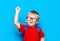 Back to school First grade junior lifestyle. Small boy in red t-shirt. Close up studio photo portrait of smiling boy in glasses