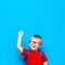 Back to school First grade junior lifestyle. Small boy in red t-shirt. Close up studio photo portrait of smiling boy in glasses