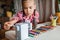 Back to school. Girl sharpening colorful pencils with a mechanical sharpener