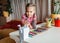 Back to school. Girl sharpening colorful pencils with a mechanical sharpener