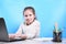 Back to school .Happy cute industrious child is sitting at a desk indoors. Kid is learning in class in home with laptop, computer