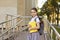 Back to school. Happy schoolgirl with a rucksack and books on the background of school in the morning.