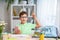 Back to school! A happy smart hardworking boy is sitting at a Desk in the room