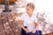 Back to school and happy time Cute industrious child sitting outdoors. Girl reading the book