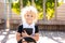 Back to school and happy time Cute industrious child sitting outdoors. Girl reading the book