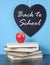 Back to School heart blackboard with red apple and stack of books