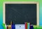 Back to school image of school or office supplies in a flat lay design with a blackboard in the center