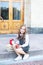 Back to school. Little girl schoolgirl sits on the steps near the school and holds an apple in her hands for lunch. Education and