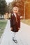 back to school. little happy kid pupil schoolgirl eight years old in fashion uniform with