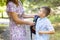 Back to school. Mother saying goodbye to her son as he leave for School. Schoolboy is ready go to school. First day at school