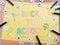 Back to school pastel colour doodle with cute stationery elements chalk drawing on a yellow paper background and colourful oil pas