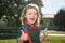 Back to school. Portrait of excited schoolboy from elementary school at the school yard.