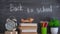 Back to school. School background, rotating clock on a chalkboard background with the text `Back to school`